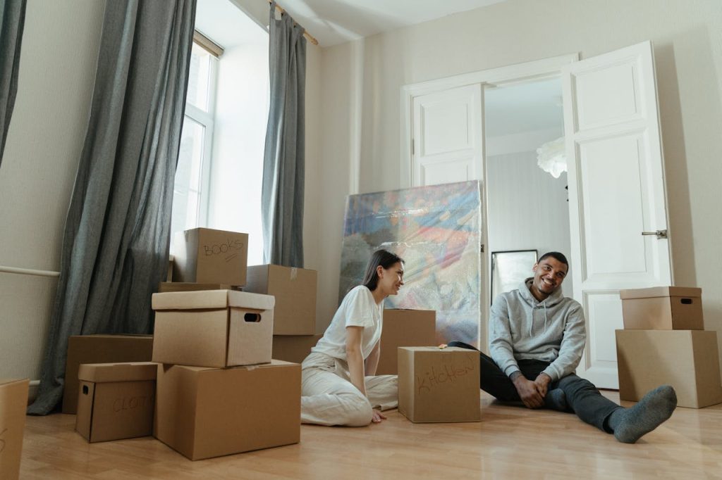 Man in Gray Long Sleeve Shirt Sitting Beside Woman in White Long Sleeve Shirt
