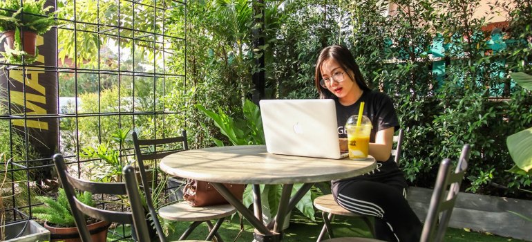 woman reading about what’s driving the rise in long-distance relocations