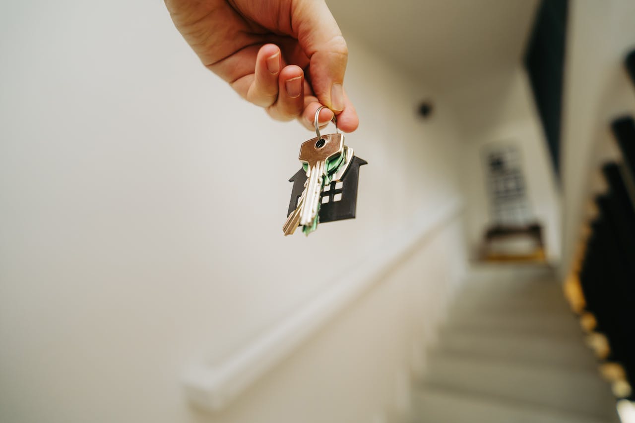 a person holding a key to their new house
