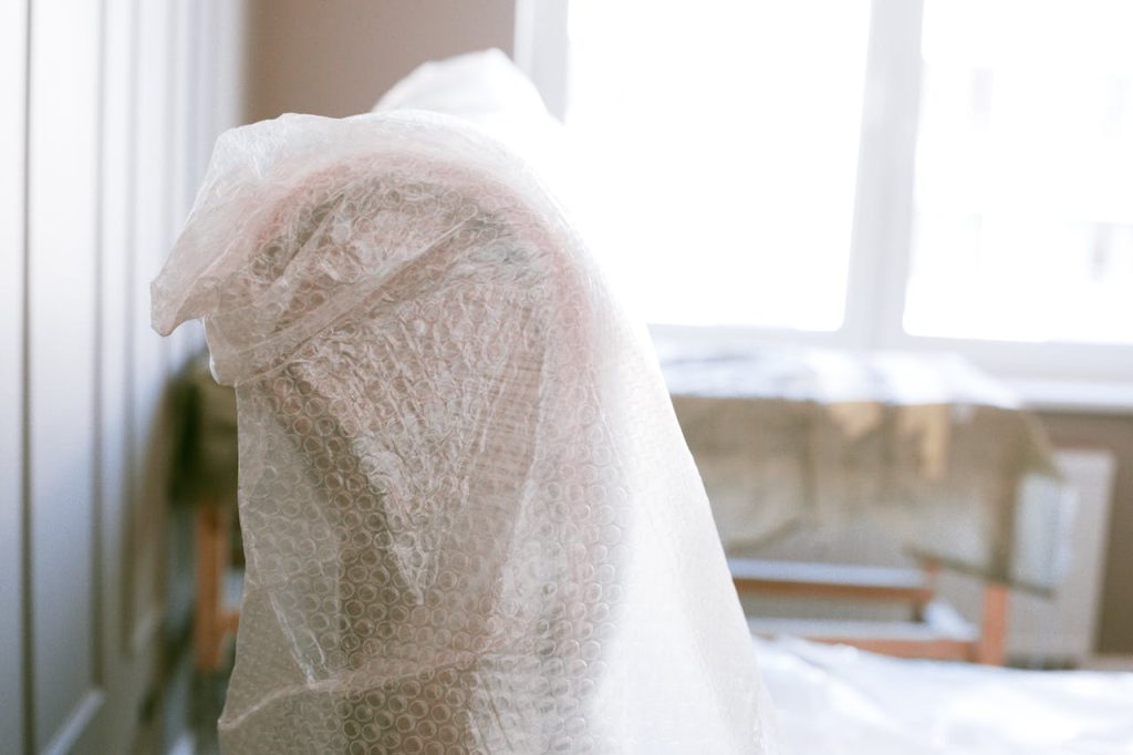 Shallow Focus Photo of Furniture With Bubble Wrap

