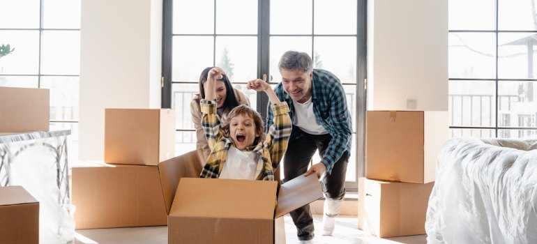 family having fun after moving into their new home
