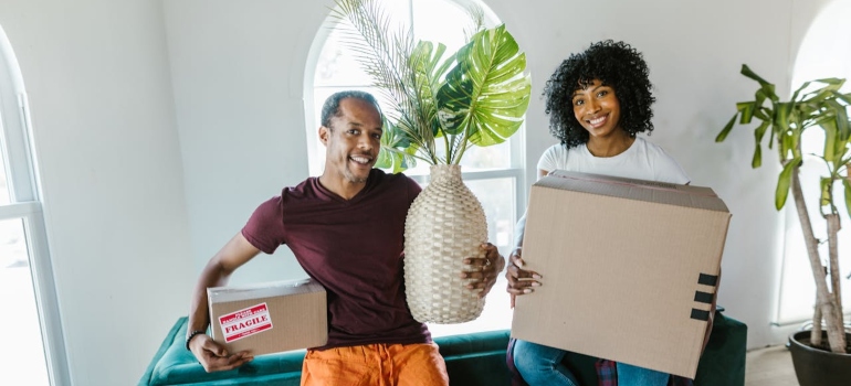 movers holding pieces of furniture