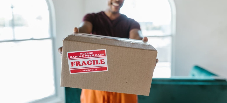 a man from long distance movers boston ma holding a box