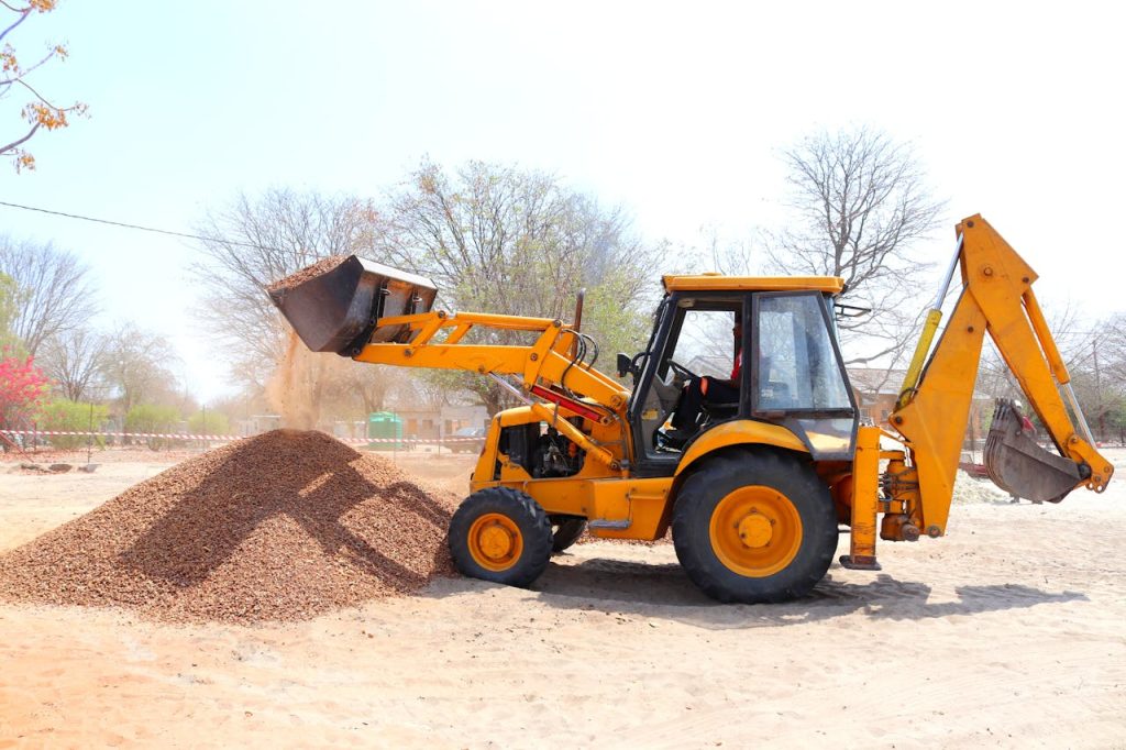 Yellow Front Loader at Construction Site waiting to be picked up by heavy equipment movers Boston