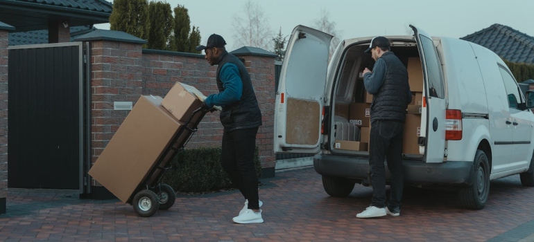 guys unloading a mini van illustrating commercial moving boston ma services 