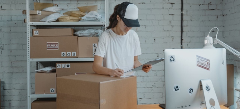 a woman looking at some documents about office moving services Boston