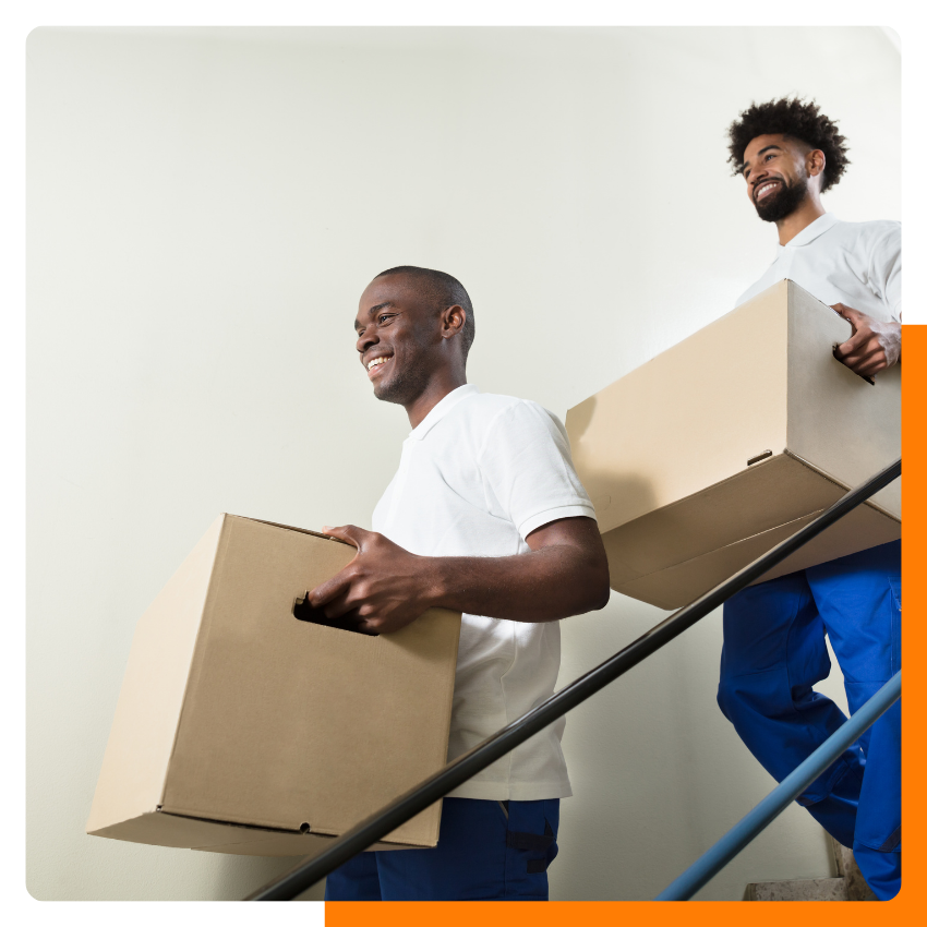 Two movers holding boxes